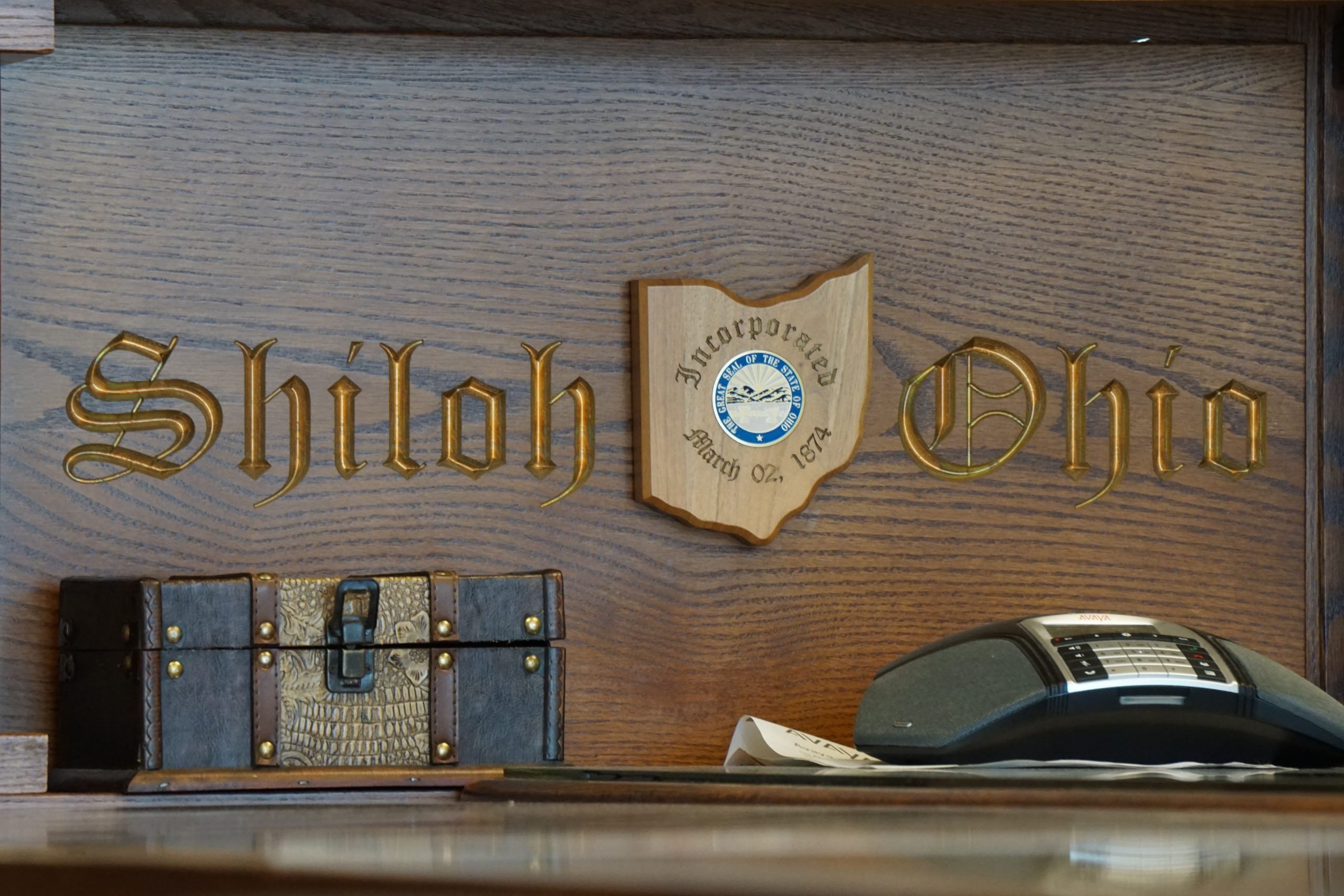 Words carved into wooden desk, with the State of Ohio in between.