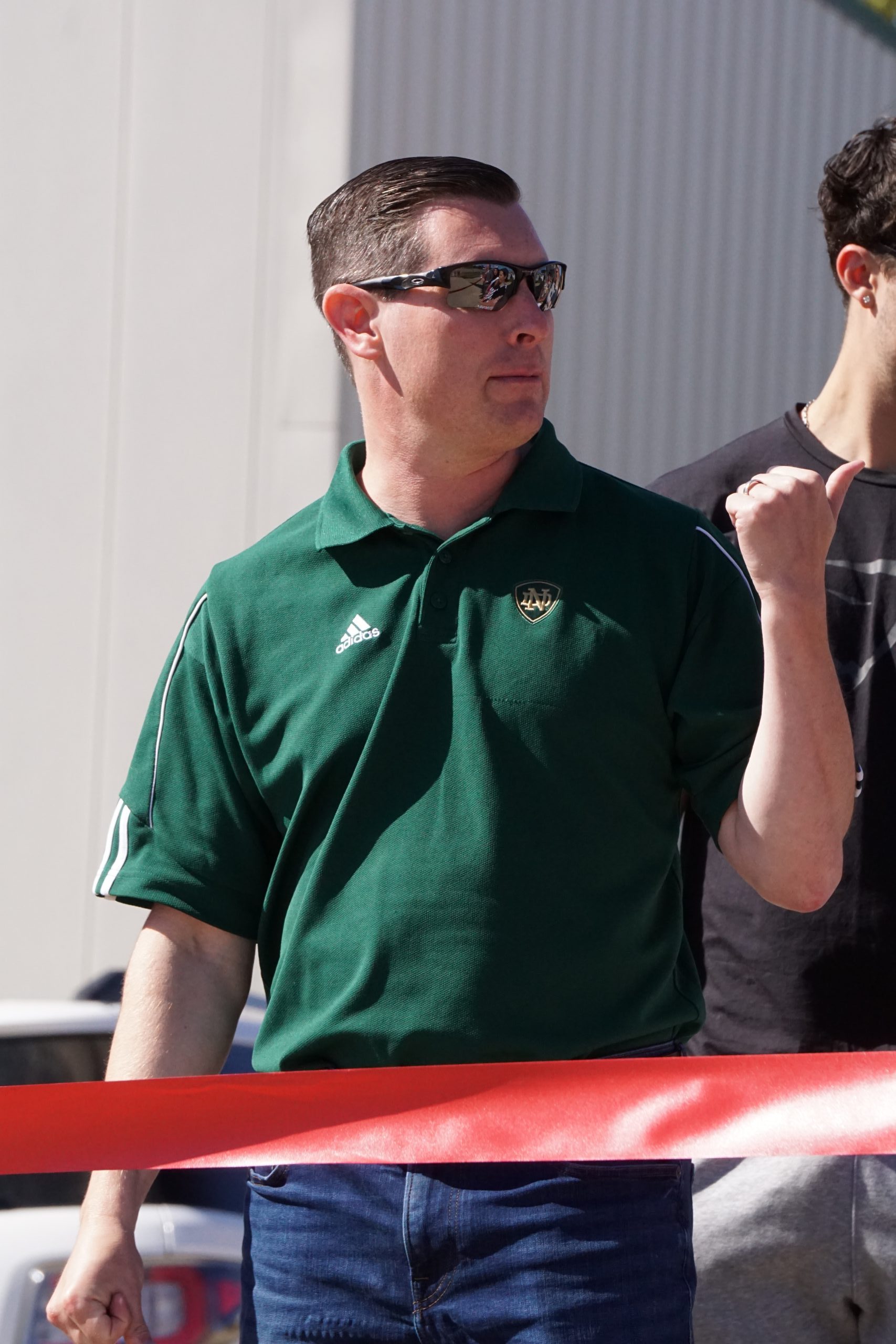 Man in green polo.