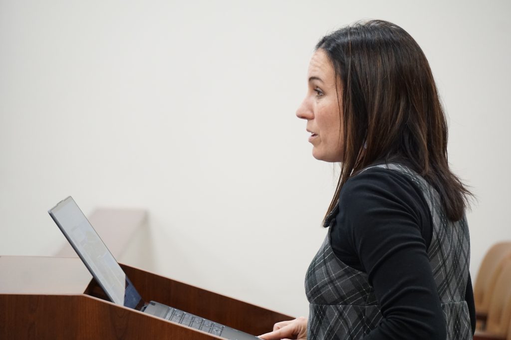 Woman speaks at podium about projects.