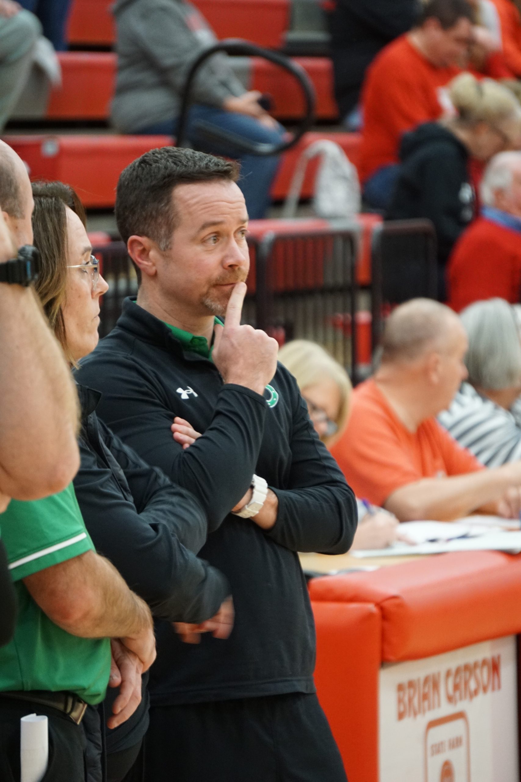 Basketball coach standing on sideline
