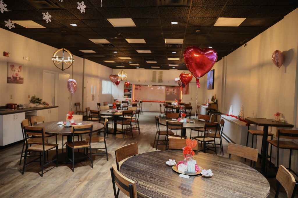 Ramble Inn, an indoor cafe with round tables and Valentine's Day centerpieces