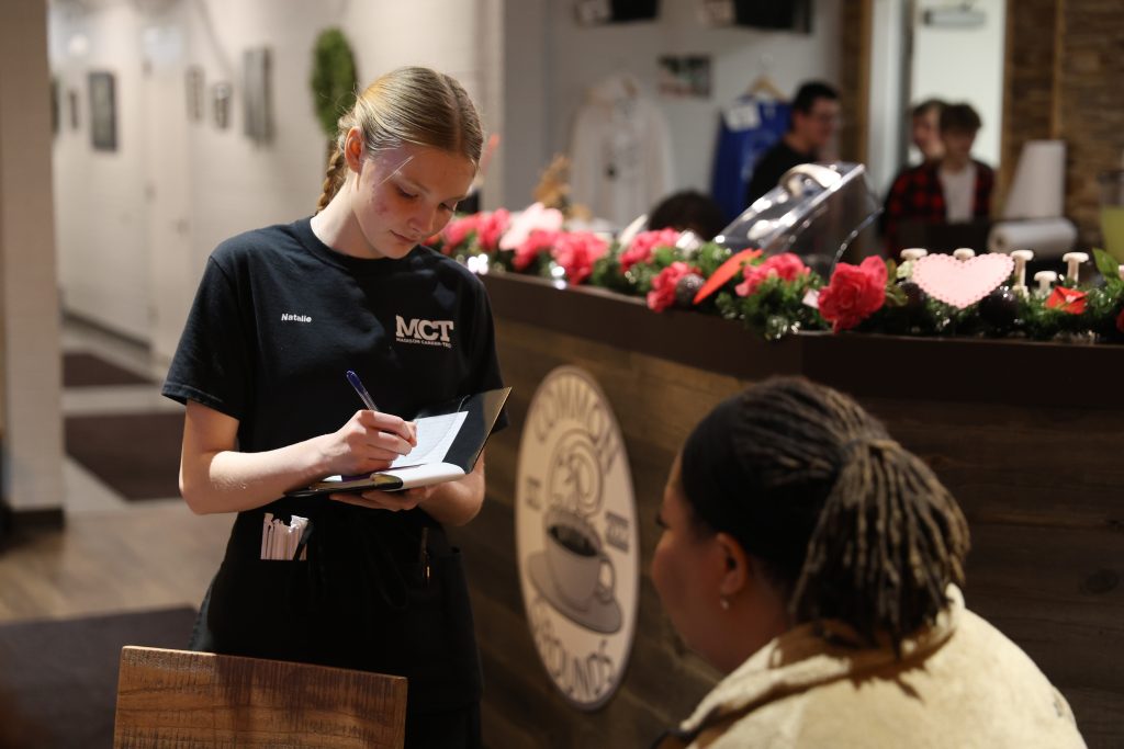 Natalie Markle, a high school junior, takes a customer's order at the Ramble Inn.