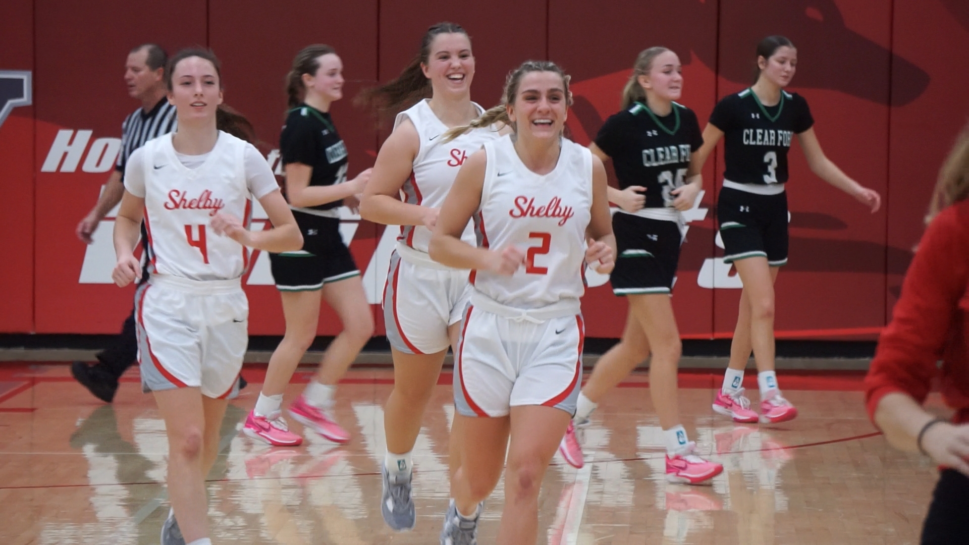 Basketball players running off of court