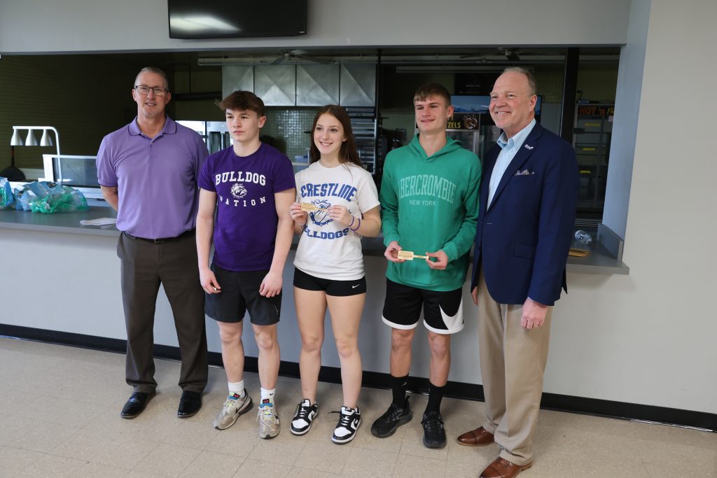 winning students pose for a photo at cardboard boat regatta